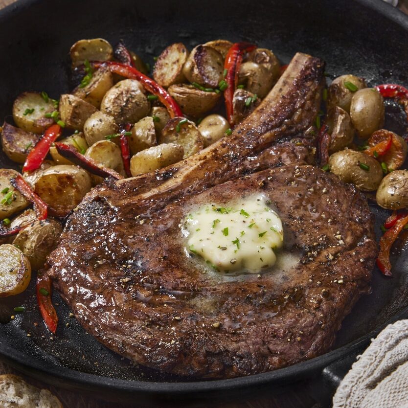 Pan Seared Rib Eye Steak with Roasted Potatoes, Red Peppers and a Garlic Herb Butter
